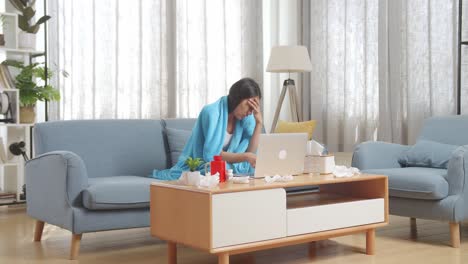 woman with headache on sofa