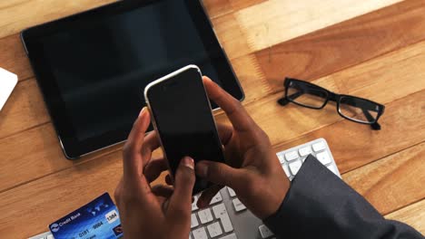 businessman making payment online using mobile phone and credit card