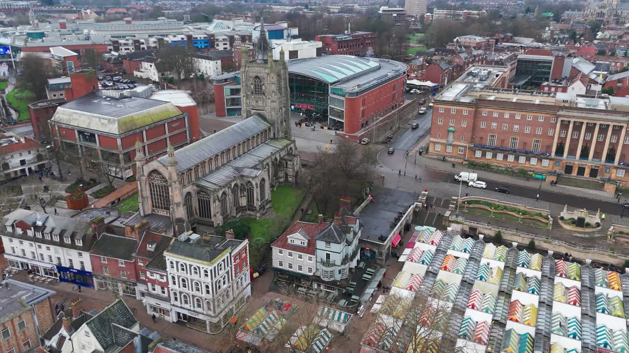 Norwich with a historic church, colorful market, and surrounding streets , aerial view