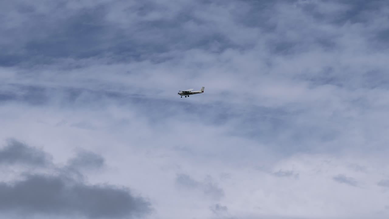 Helicopter progresses across variably cloudy skies