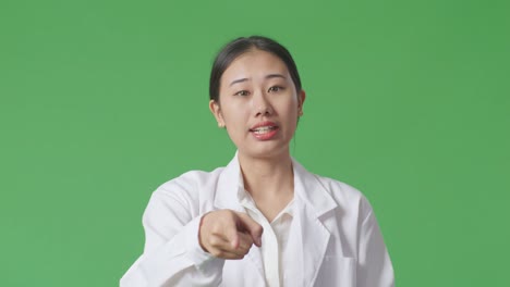 woman in lab coat pointing