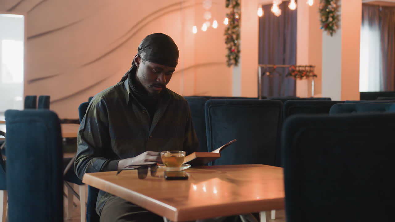 focused individual editing at cafe, creative professional revising document in welcoming coffee setting, dedicated editor immersed in work at cafe with peaceful and inviting environment