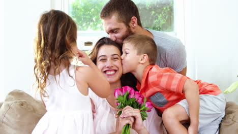 mom receiving flowers and kisses