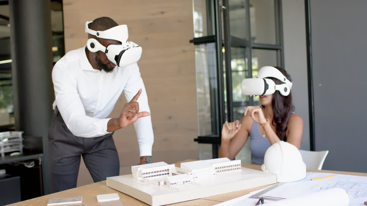 Using VR headsets, business diverse colleagues engaging with architectural model in office
