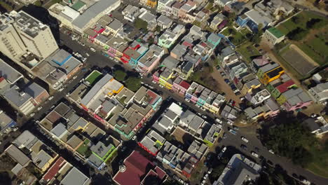 Wide-aerial-top-down-drone-shot-of-Bo-Kaap,-Cape-Town-South-Africa-neighborhood-above-Wale-and-Rose-Street-with-beautiful-colorful-houses-and-historic-architecture-of-Malay-quarters