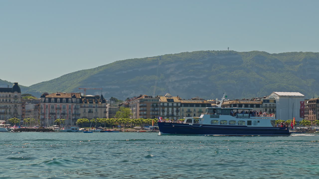Peaceful morning in Geneva with the iconic Jet d’Eau rising from the lake, calm waters reflecting the clear sky, and the city slowly coming to life in the morning light.