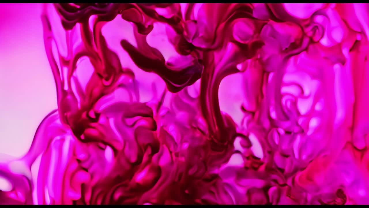 Vibrant Pink and Red Ink Swirls in Liquid