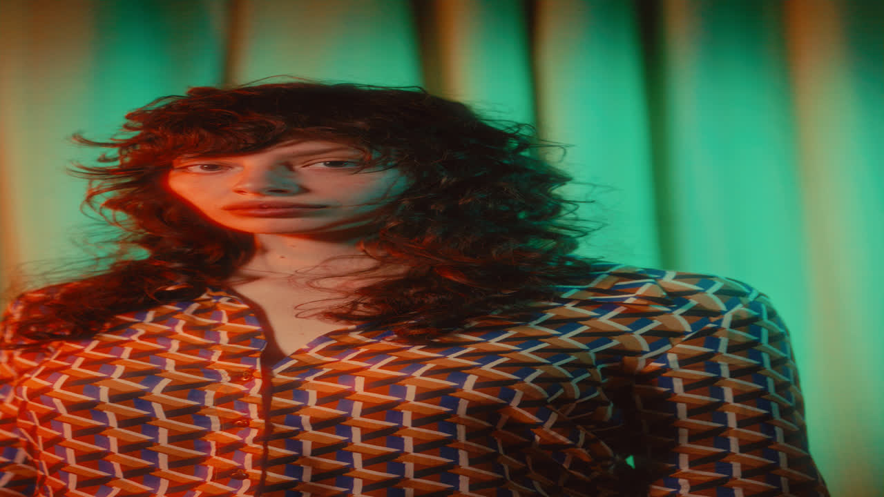 Portrait of Young Woman in Patterned Shirt under Retro Lighting