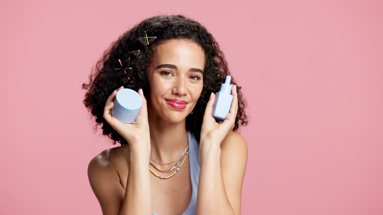 Woman with Curly Hair Holding Skincare Products