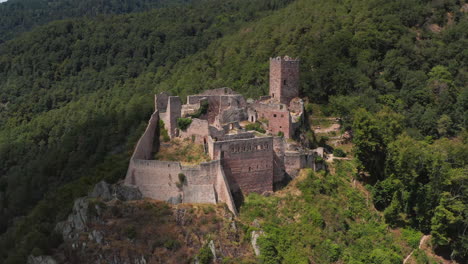 revealing aerial shot of a medieval castle in the alsace region of france.