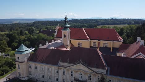 drone is flying over by a church tower from above