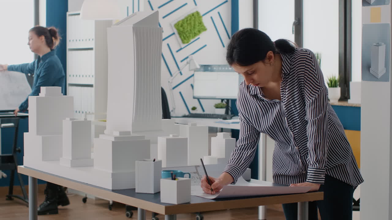 Architects working on building model in office