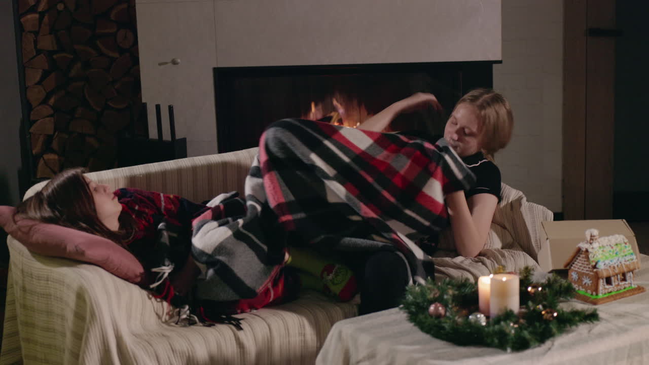 Family relaxing by the fireplace at Christmas