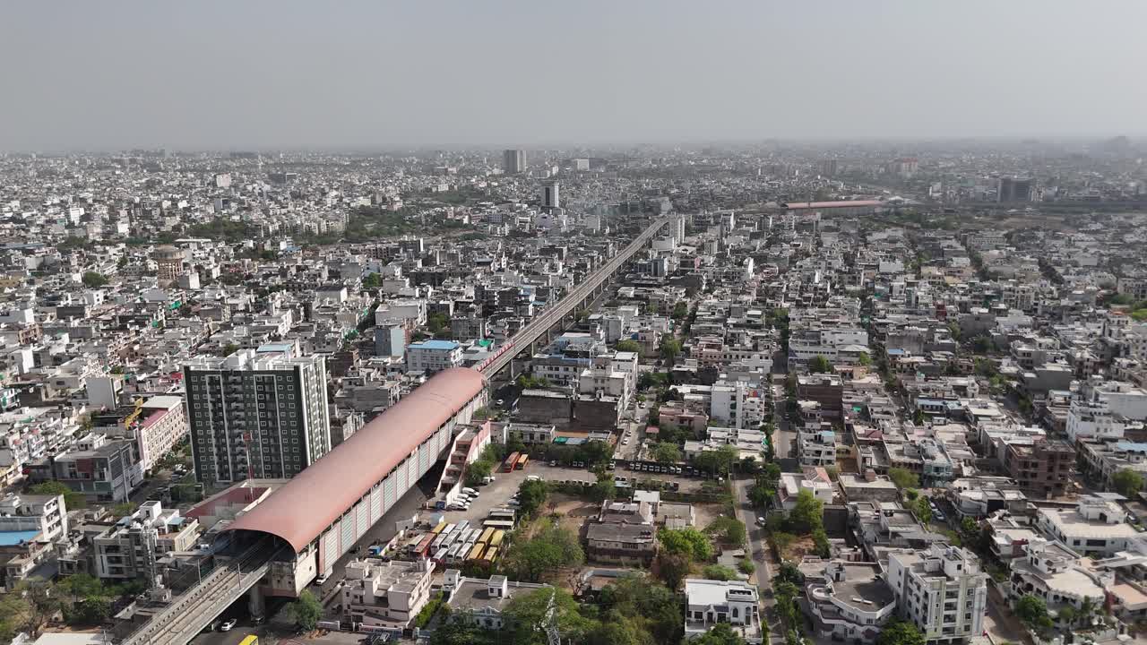 Scenic drone footage of Jaipur's crowded roads with metro station