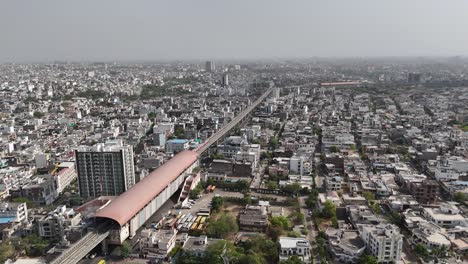 scenic drone footage of jaipur's crowded roads with metro station