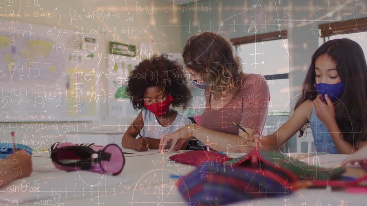 Animation of mathematical equations over diverse schoolchildren and teacher wearing face masks