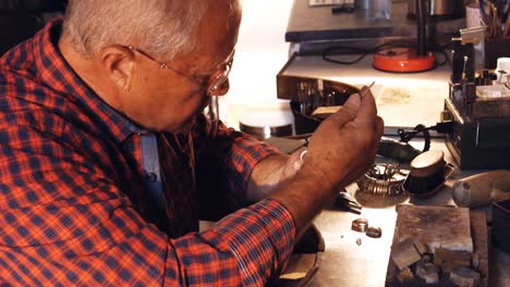 Goldsmith-fixing-diamond-on-ring