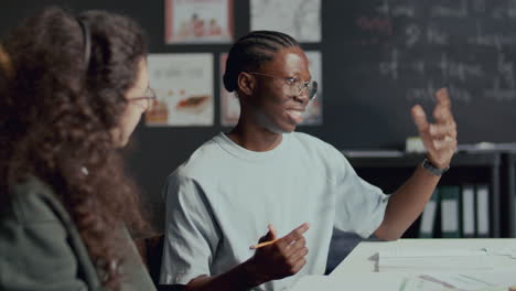 young african american student talking to friend in english class