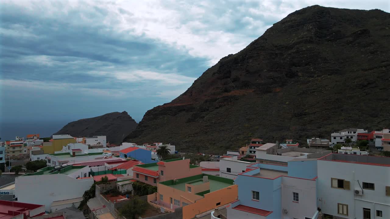 Aerial Flyover Colorful Houses on Mountainside Village in the Grande Mountains, Spain