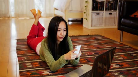 woman using mobile phone in living room