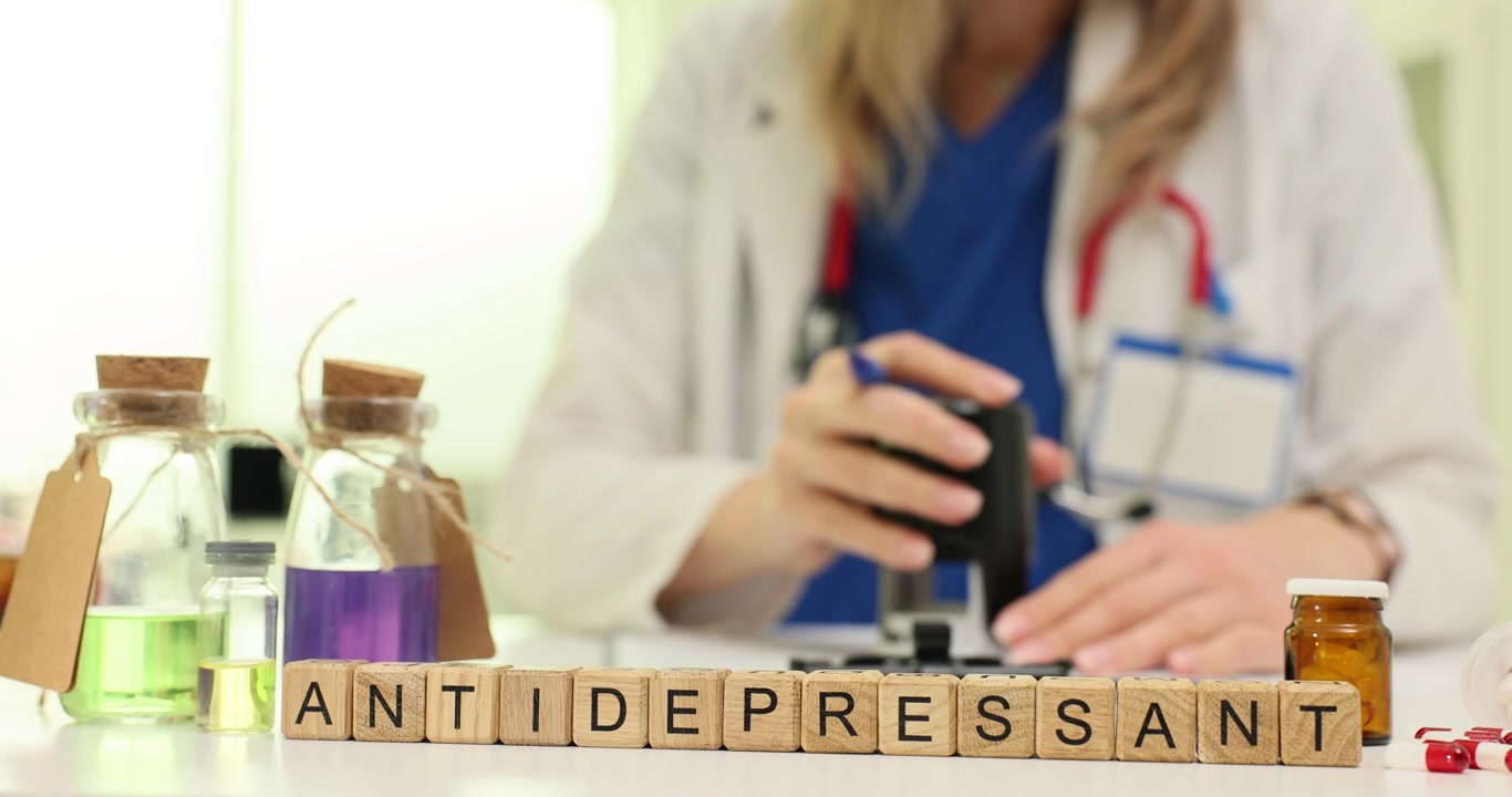 Word antidepressant against doctor putting stamp on papers