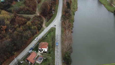 cars on a motorway intersection between a village and a pond,czechia