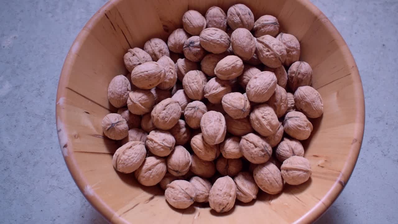 Dried walnuts in a wooden bowl