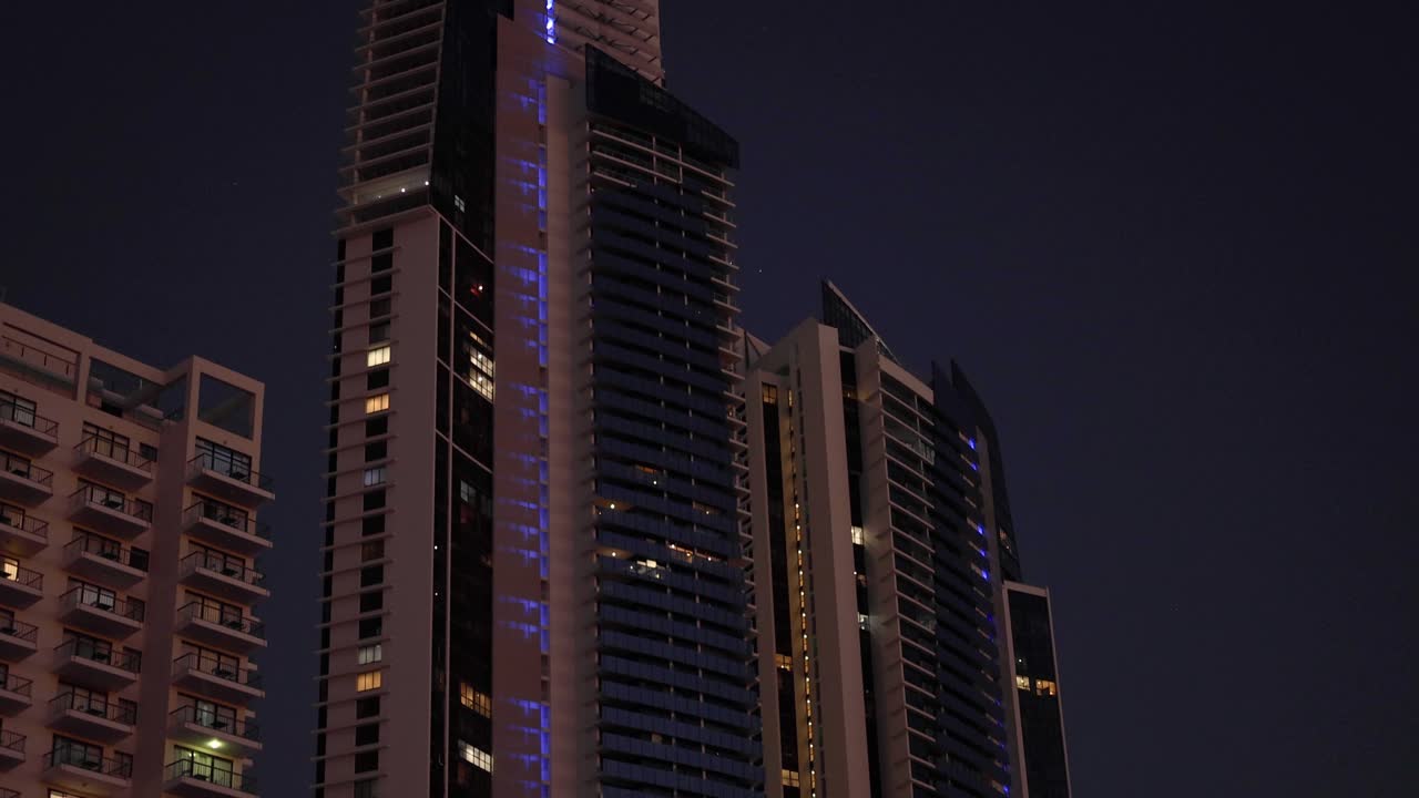 rascacielos iluminados contra el cielo nocturno