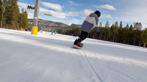 adolescent boy riding a snowboard footage in breckenridge, colorado