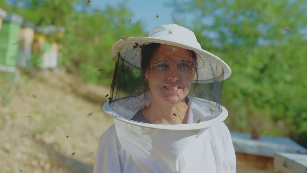 Woman Beekeeper Working in an Apiary with Bees