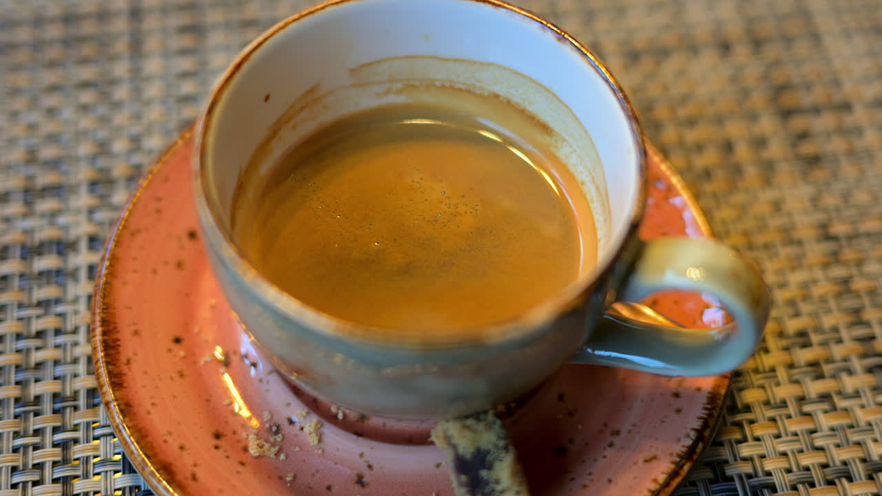 Cup of coffee in a ceramic mug in a rustic environment