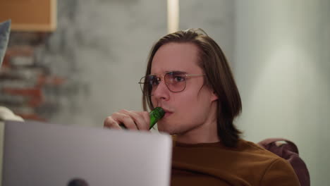 hombre tenso con la computadora bebe cerveza y sonríe de meta