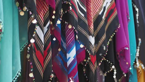 colorful scarves hanging in a market stall