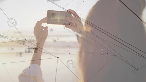 taking photo with smartphone, person capturing network connections with animation