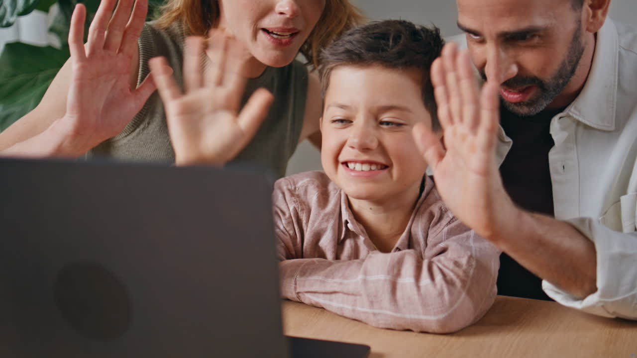 Little kid greeting videocall at light interior closeup. Happy family talking