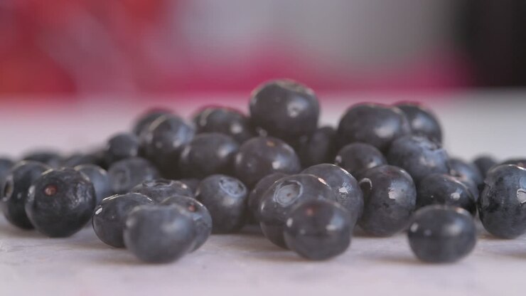 Close on Blueberries Poured Onto Chopping Board