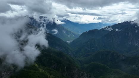clouds over the mountain range in theth, shkoder county, albania. - aerial pullback shot