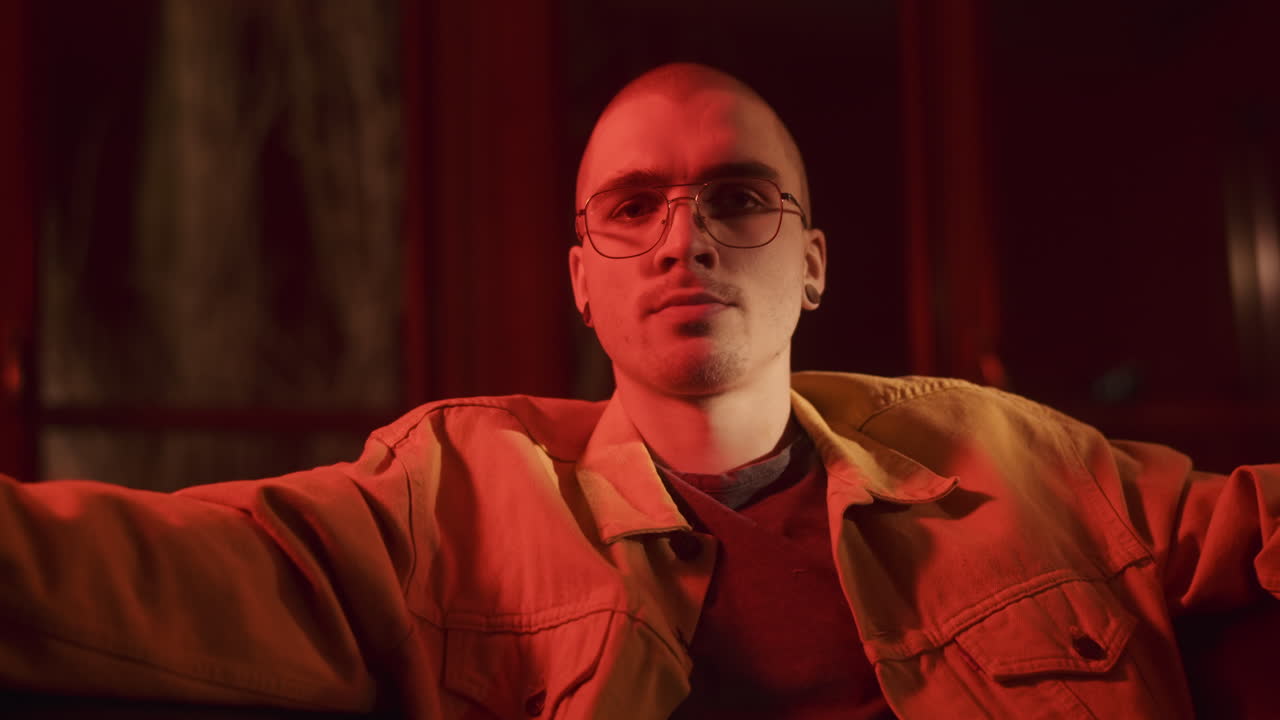 Man in a Yellow Jacket Under Red Light