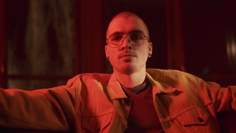 man in a yellow jacket under red light