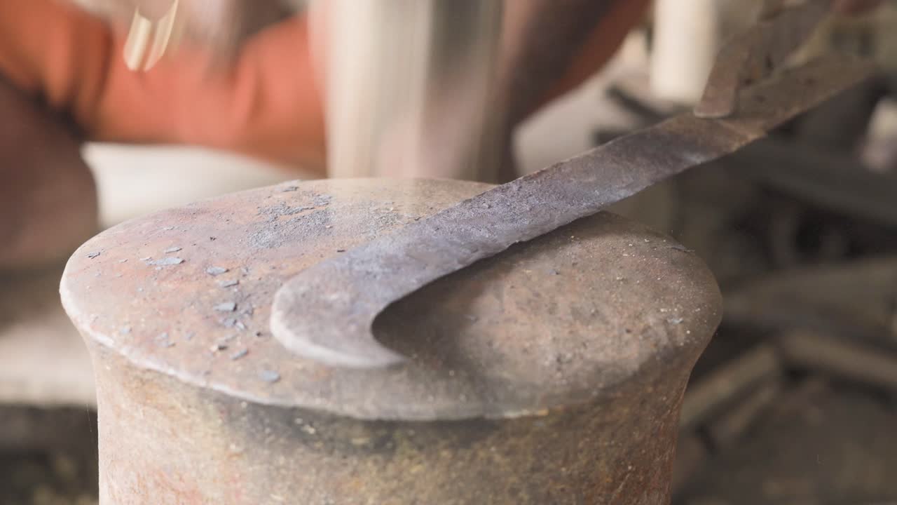 Forging meat knife by hammering at a blacksmith's workshop
