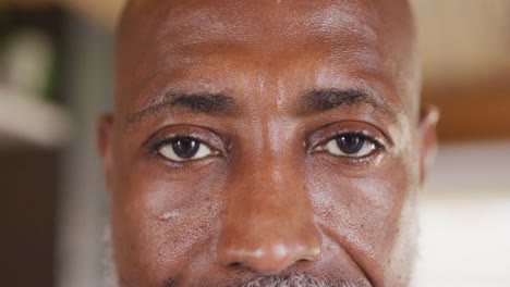 Portrait-of-happy-senior-african-american-man-spending-time-in-log-cabin,-slow-motion