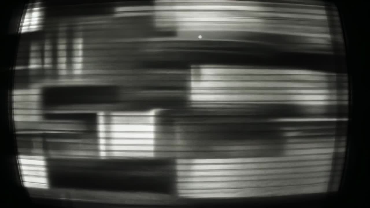 Opening frame showing test pattern shifting across CRT monitor looping into original configuration