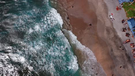 Tourists-At-Crystal-Bay-Beach-In-Nusa-Penida,-Bali,-Indonesia---aerial-top-down