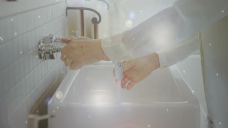 animation of macro coronavirus covid-19 cells spreading over man washing his hands in a sink