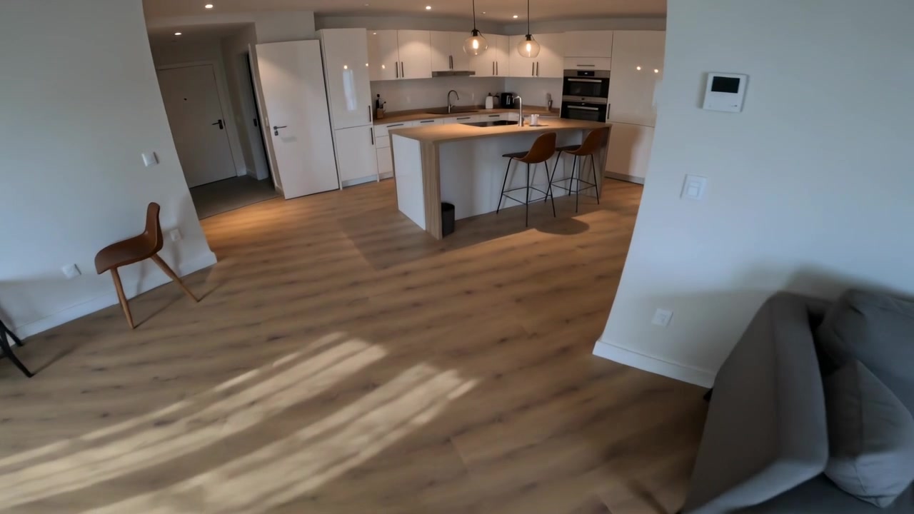 Walking camera-holder from curtains, moving through room to reach kitchen island, in gray top