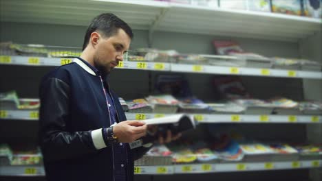 man browsing magazines in a bookstore