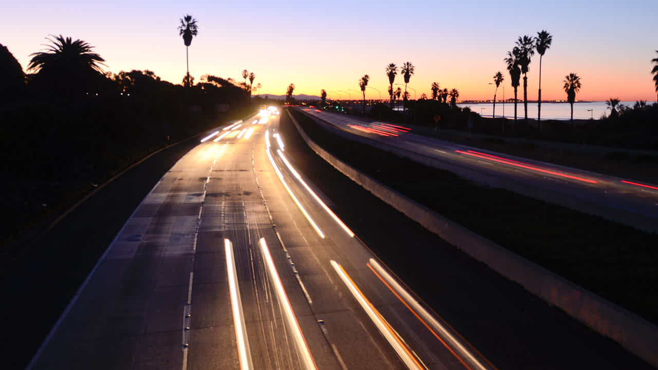 Time lapse  cars travel on a freeway at sunset or dusk 2