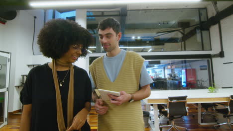 friends walking through office and chatting during workday