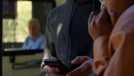 couple interacting with each other while using mobile phone 4k