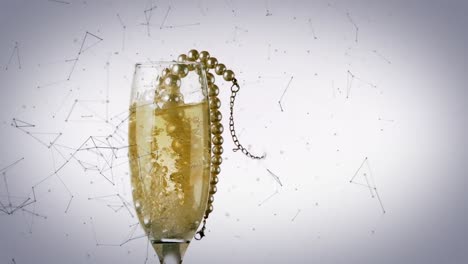 Animation-of-pearl-necklace-falling-into-glass-of-champagne-on-white-background